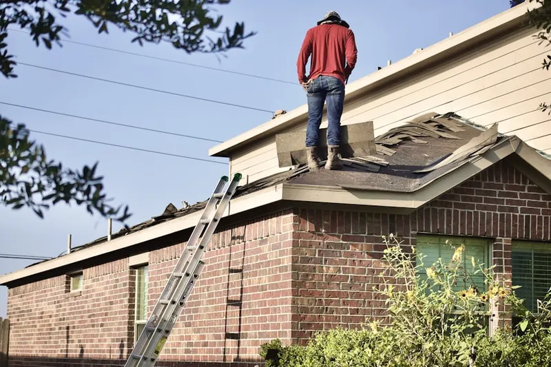 Professional roofer working on a residential roof in Delphi